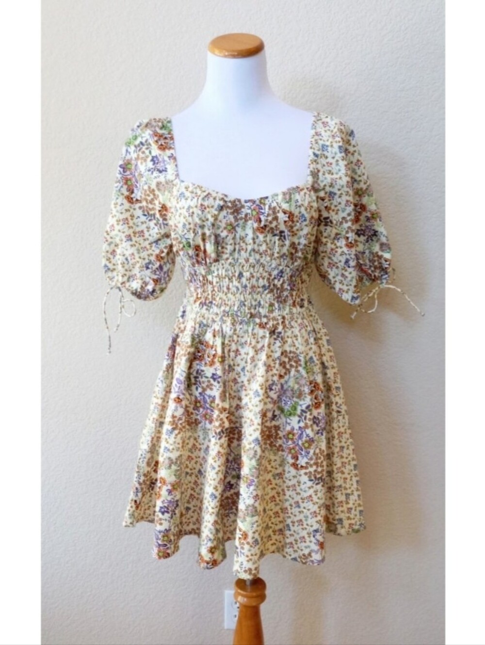 Olivaceous cream floral puff sleeve and smocked bodice for a fitted waist dress